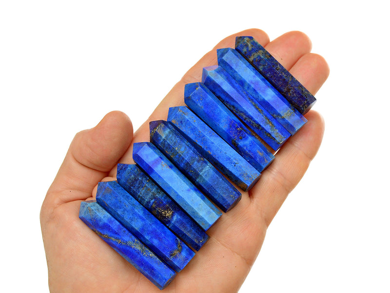 Ten lapis lazuli small crystals points 50mm on hand with white background