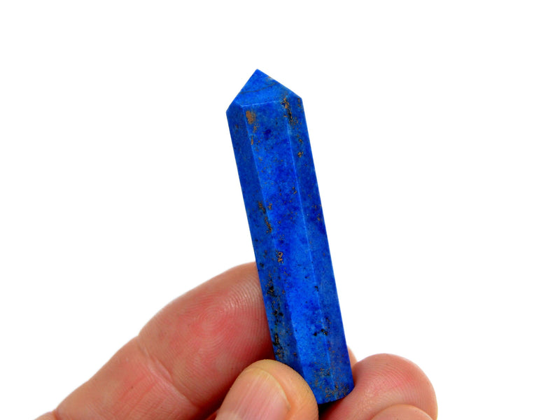 One blue lapis lazuli crystal prism 50mm on hand with white background
