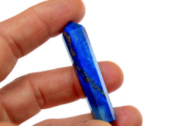 One cobalt blue lapis lazuli mini tower crystal 50mm on hand with white background