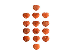Several small orange calcite shapped heart stones 30mm on white background