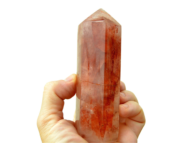 One large and thick hematoid quartz faceted crystal point 110mm on hand with white background