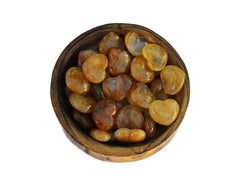 Several golden healer quartz hearts 30mm inside a wood bowl on white background