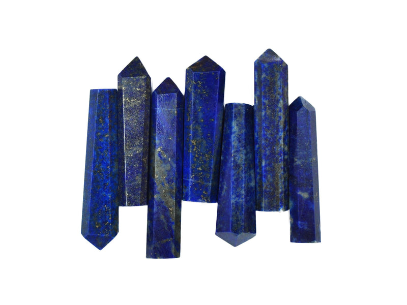 Seven lapis lazuli faceted point crystals 45mm-50mm on white background
