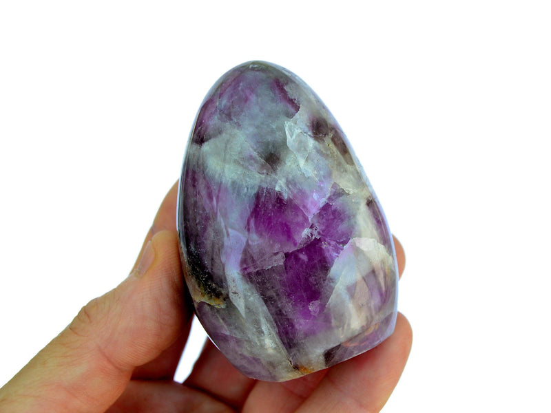 One large amethyst free form crystal on hand with white background