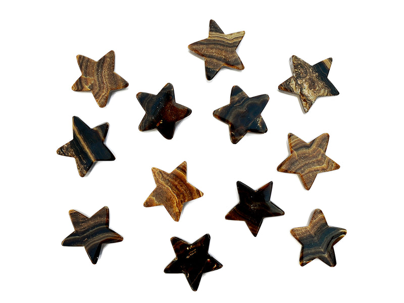 Several chocolate calcite star carved crystals 55mm-60mm on white background