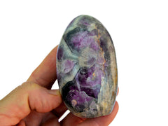 One large amethyst free form stone 100mm on hand with white background