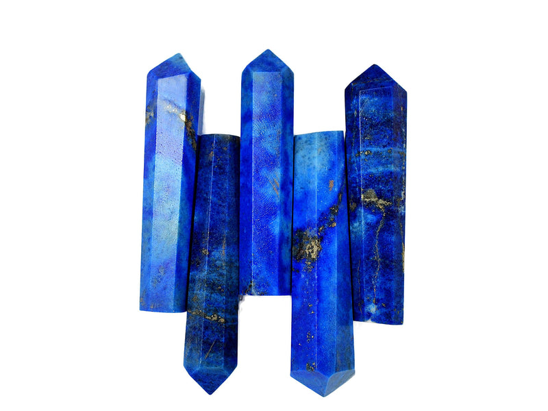 Five cobalt blue lapis lazuli faceted points on white background