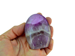 One amethyst quartz free form 60mm on hand with white background