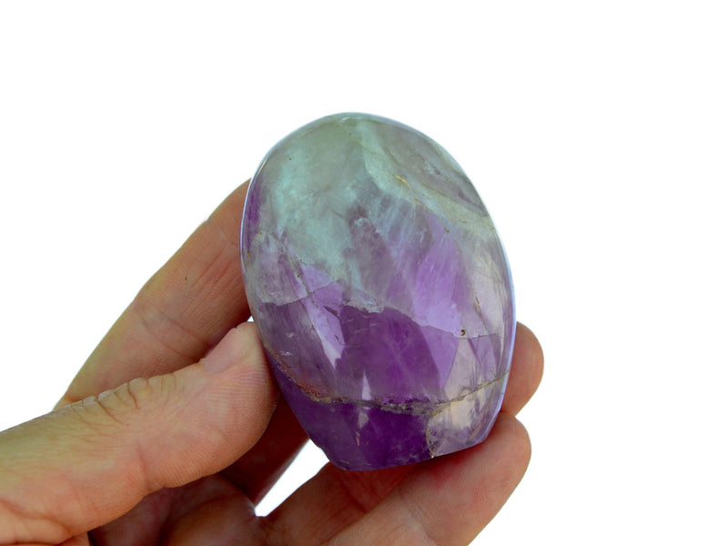 One amethyst crystal free form 60mm on hand with white background