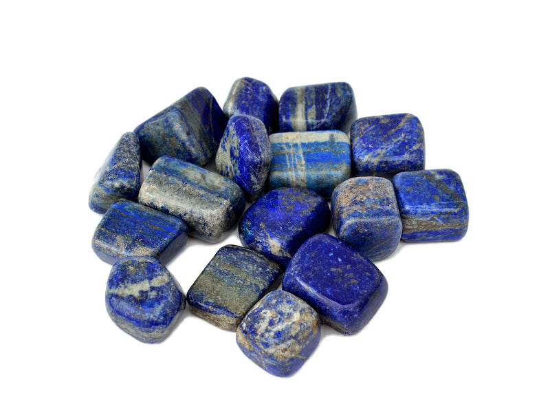 Some lapis lazuli tumbled minerals on white background