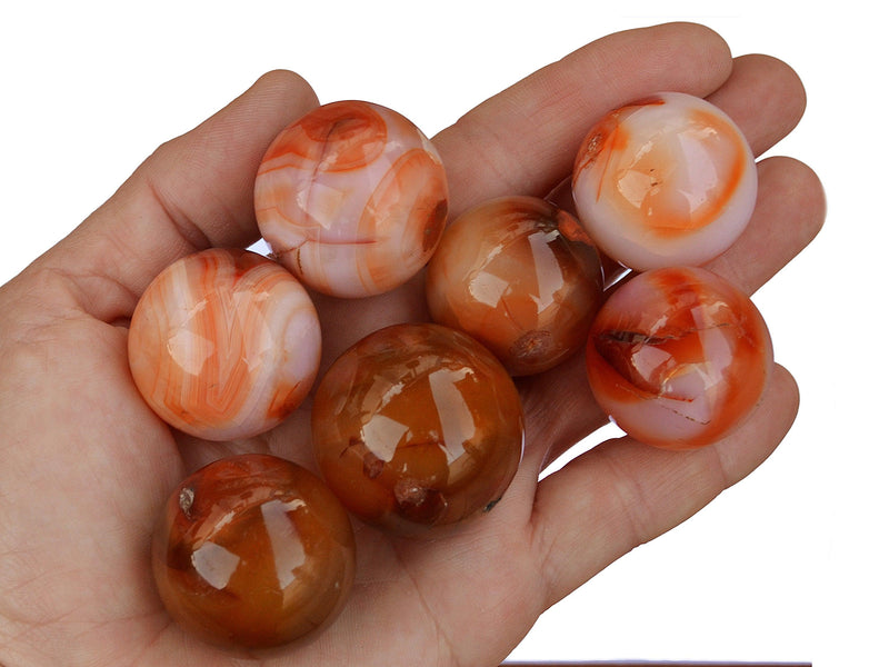 Severan carnelian crystal balls 35mm-40mm on hand with white background