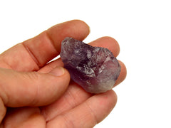 One raw amethyst crystal 30mm on hand with white background