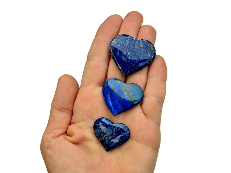 Three lapis lazuli hearts 25mm-40mm on hand with white background