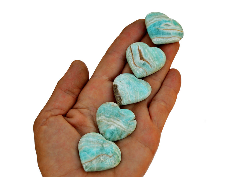 Five blue aragonite small heart crystals 30mm35mm on hand with white background