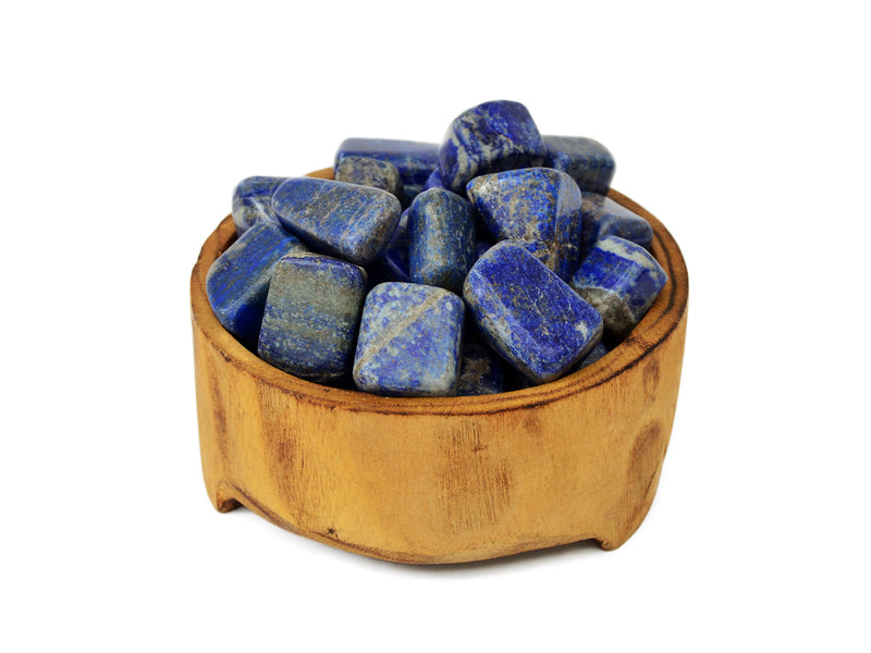 Some lapis lazuli tumbled minerals 20mm-30mm inside a wood bowl on white background