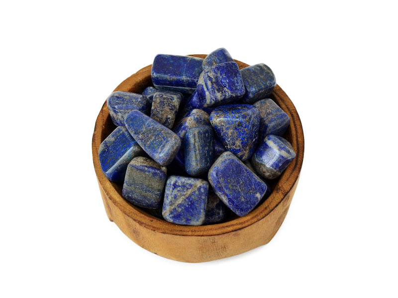 Some lapis lazuli tumbled stones 20mm-30mm inside a wood bowl on white background