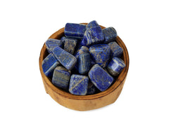 Some lapis lazuli tumbled stones 20mm-30mm inside a wood bowl on white background