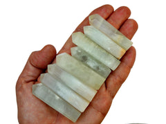 Eight caribbean calcite point crystals 55mm-60mm on hand with white background