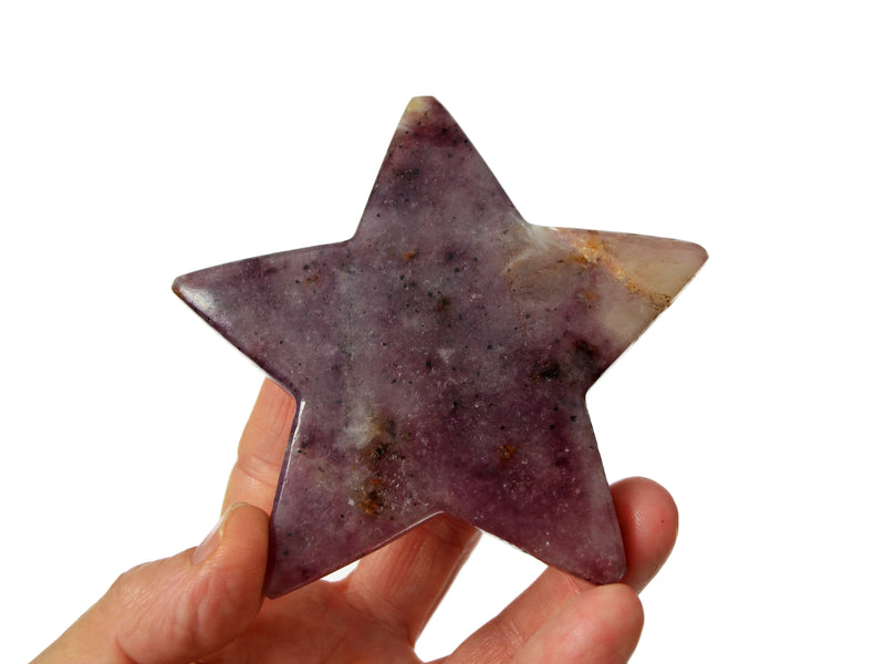 One lepidolite star crystal on hand with white 95mm background 