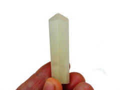 One mini blue caribbean calcite crystal point on hand 60mm with white background