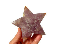 One purple lepidolite star crystal on hand with white 95mm background 