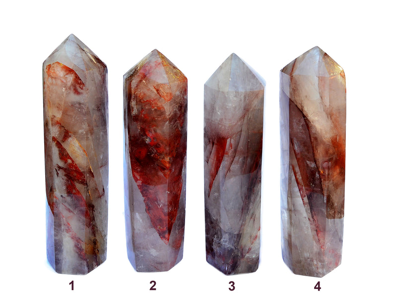 Four large hematoid quartz crystal obelisks 240mm on white background 