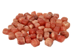 Several rose calcite tumbled tones on white background