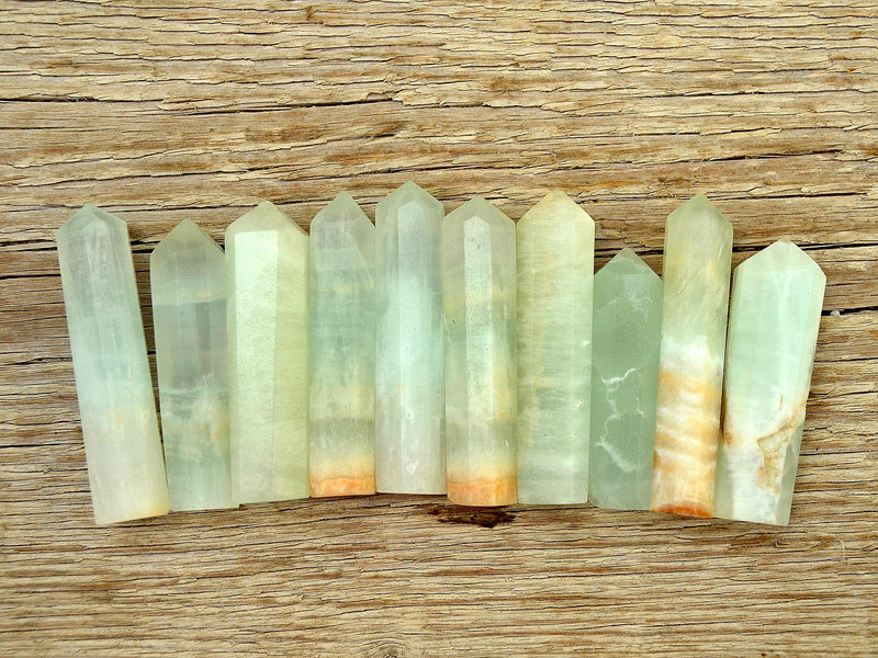 Ten green blue caribbean calcite point crystals 55mm-60mm on wood table