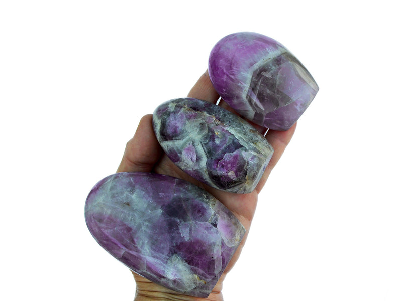 Three amethyst quartz free forms 55mm-100mm on hand with white background