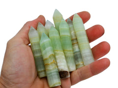 Some sea foam calcite generator points 65mm-70mm on hand with white background