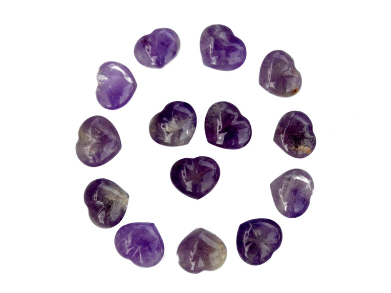 Several amethyst crystal hearts 30mm forming a circle on white background
