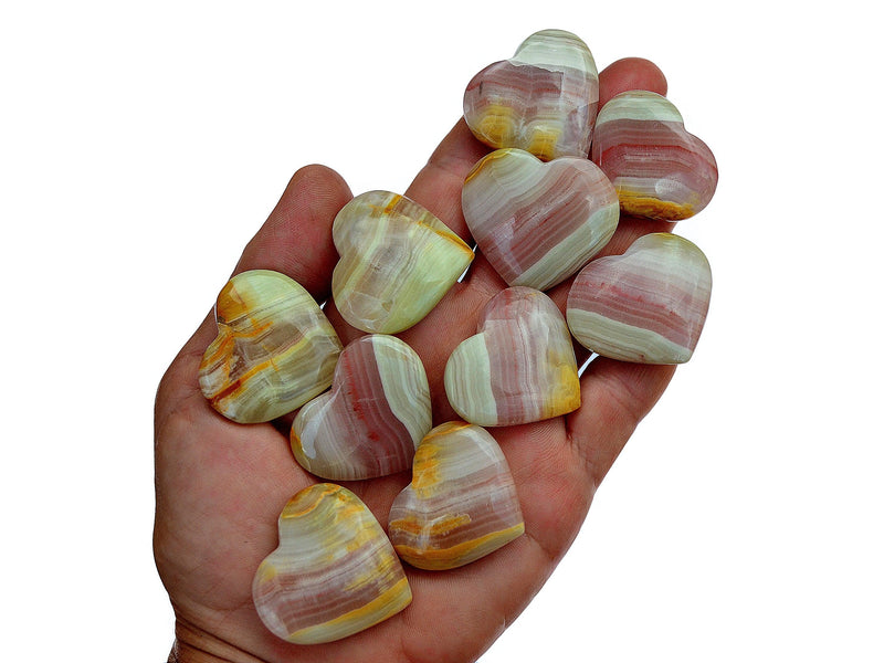 Ten pink banded onyx heart crystals 30mm on hand with white background