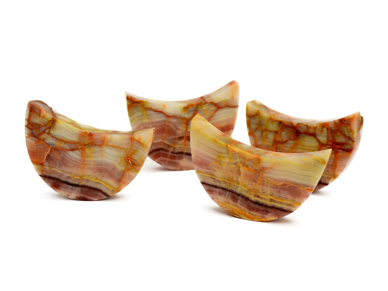 Four pink banded onyx crescent moon crystals 80mm-85mm on white background