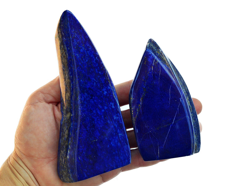Two lapis lazuli free form slab crystals 90mm-130mm on hand with white background