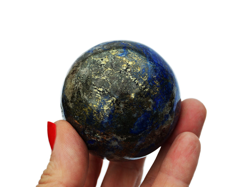 One lapis lazuli sphere crystal 50mm on hand with white background