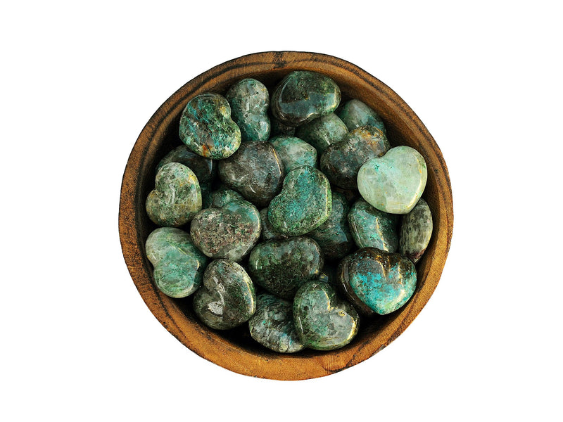 Several green chrysocolla mini hearts 30mm inside a wood bowl on white background