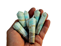 Six blue aragonite crystal points 45mm on hand with white background