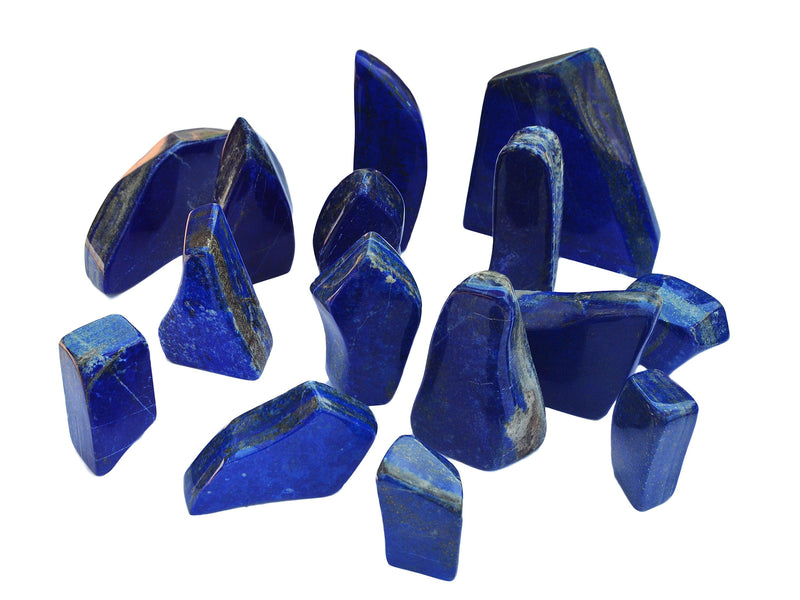 Several blue lapis lazuli free form crystals on white background