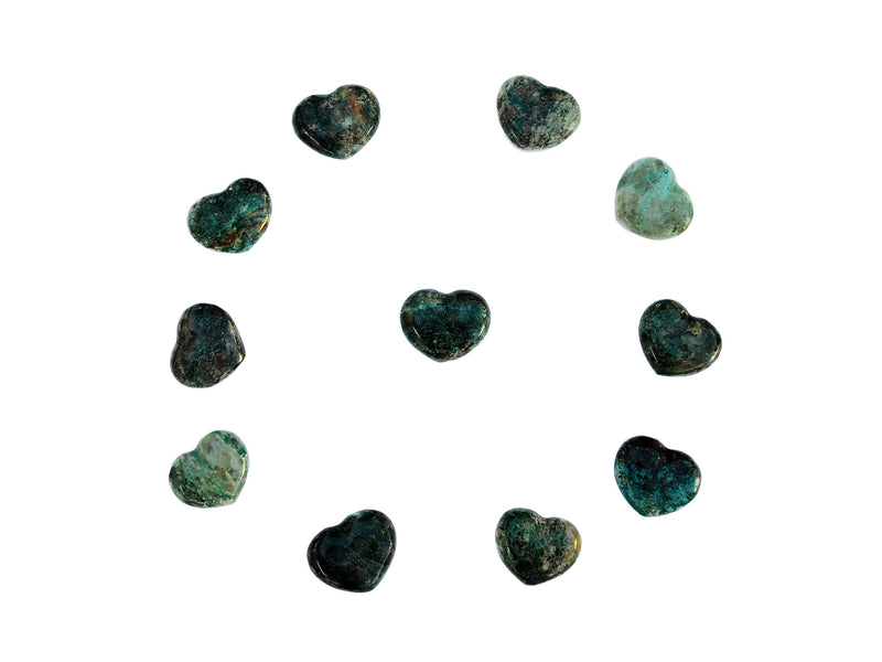 Some mini green chrysocolla hearts crystals 30mm forming a circle on white background