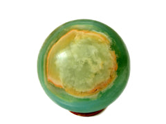 Extra large pistachio calcite sphere crystal 100mm on white background