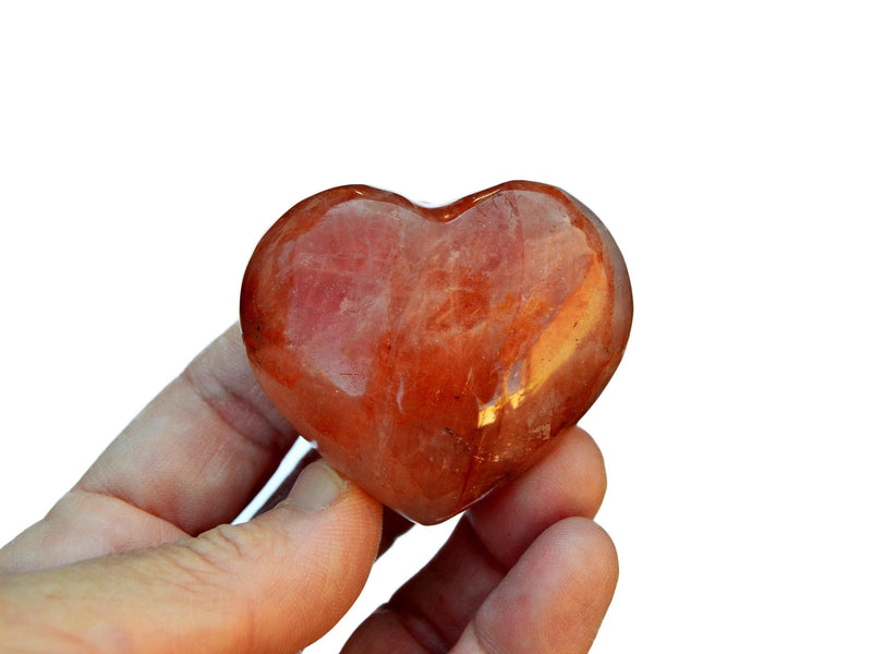One small fire quartz heart crystal 45mm on hand with white background