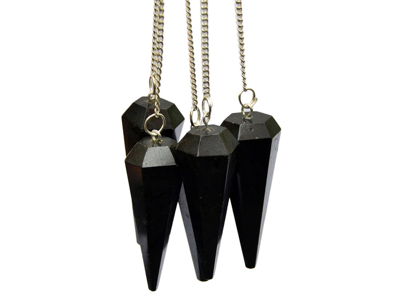 Four black tourmaline faceted point pendulums with silver chain holding on white background