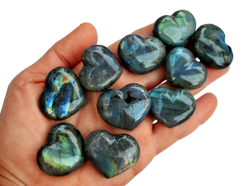 Ten labradorite heart shapped crystals 30mm on hand with white background