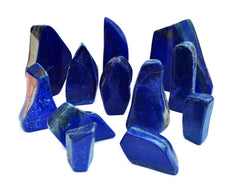 Several natural blue lapis lazuli free form slabs 45mm-150mm on white background
