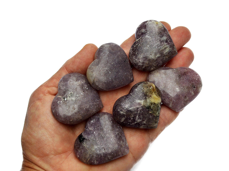 Six lepidolite crystal hearts 35mm-40mm on hand with white background