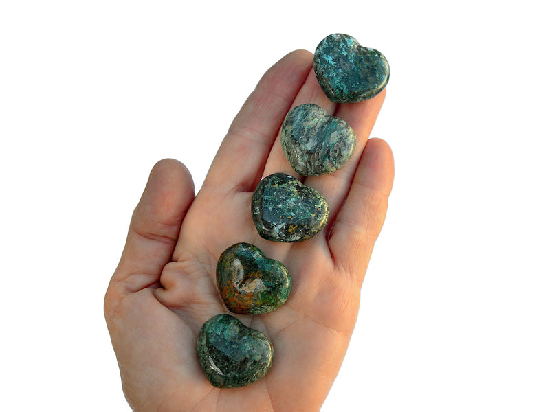 Five green chrysocolla crystal hearts 30mm on hand with white background