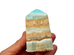 One large caribbean calcite tower on hand with white background