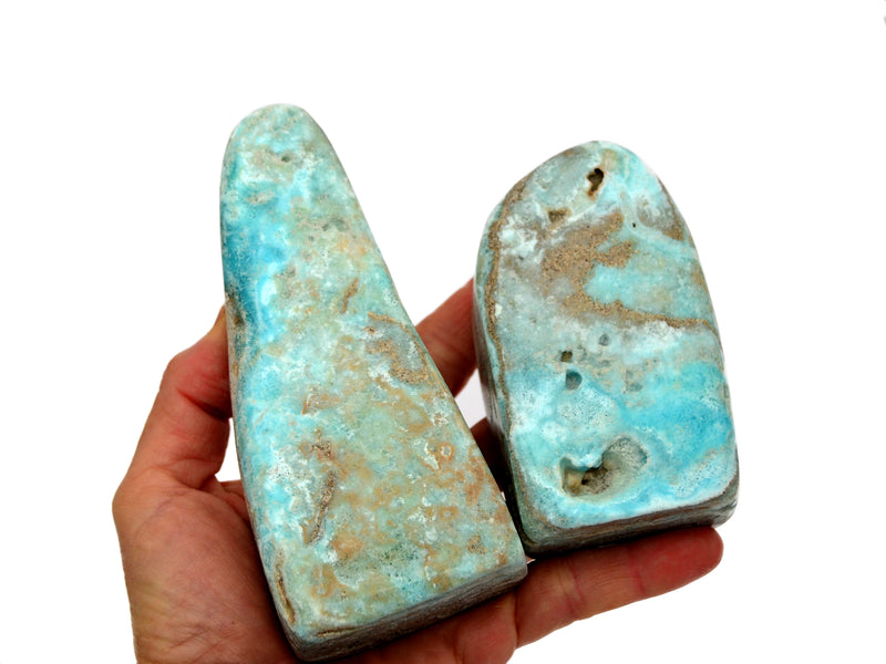 Two blue aragonite free forms 80mm-90mm on hand with white background