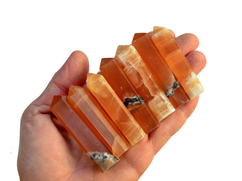 Seven honey calcite  small crystal points 55mm-60mm on hand with white background