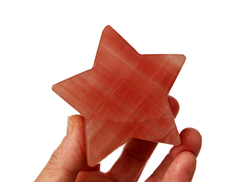 One rose calcite star crystal 78mm on hand with white background